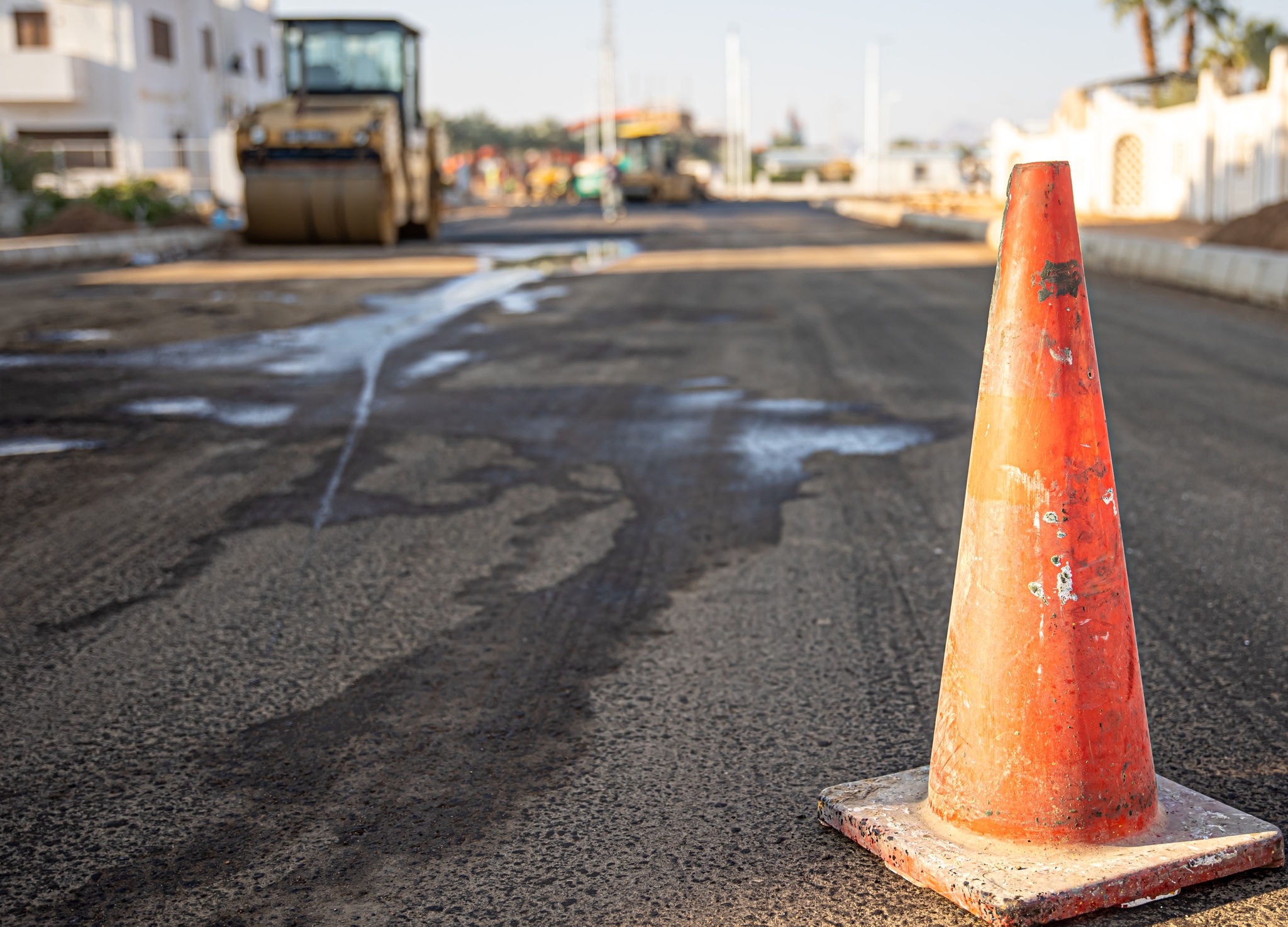 Close up of an orange traffic cone on the road copy space.