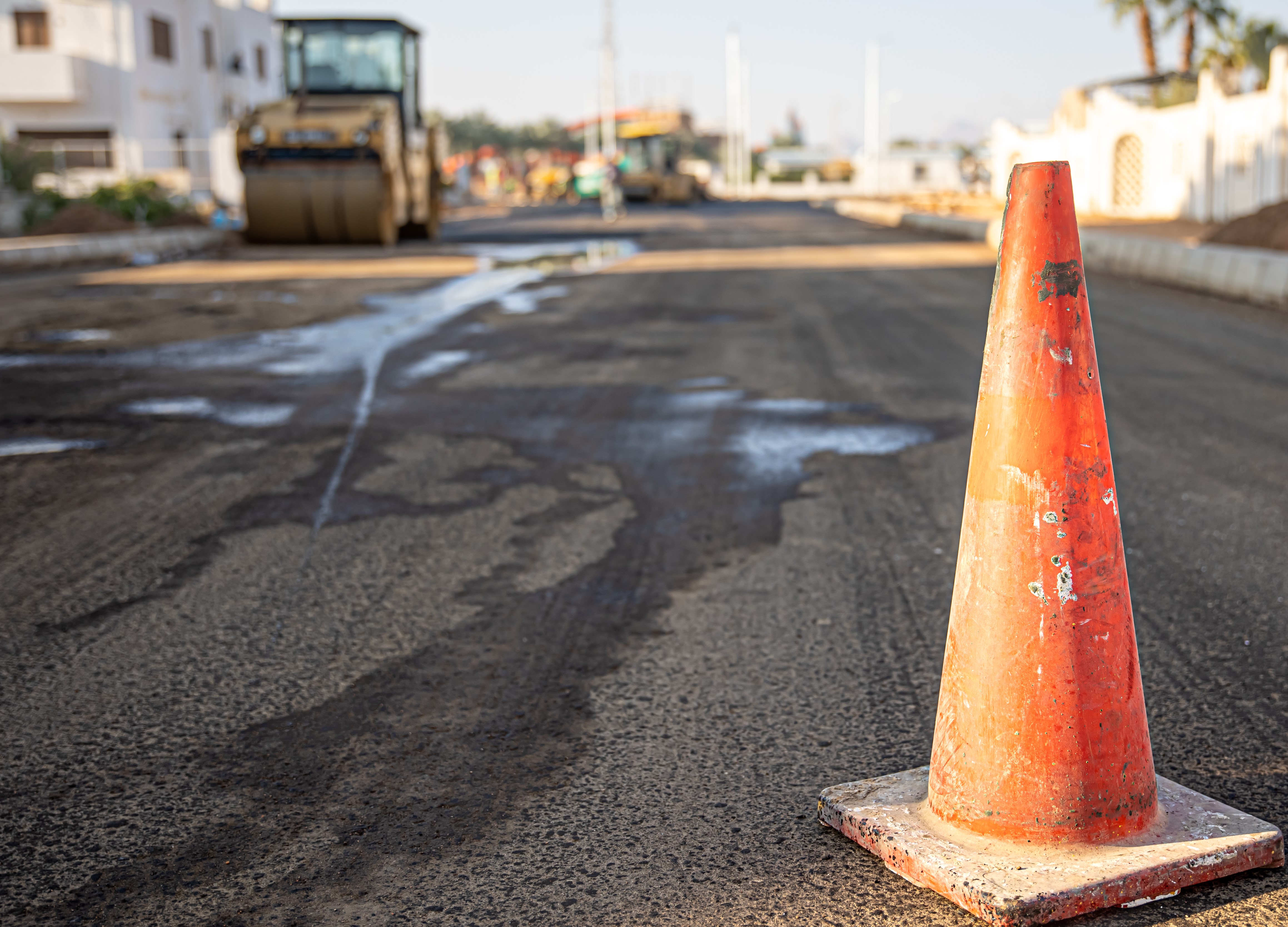 Close up of an orange traffic cone on the road copy space.